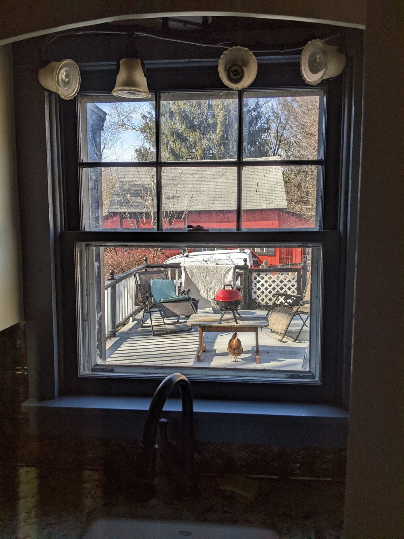 Window with a custom wood sill and trim installed in a kitchen